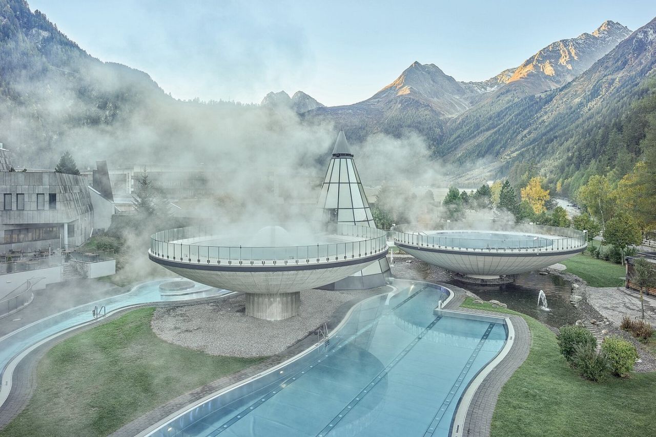 Aqua Dome Längenfeld outdoor thermal spa bowls surrounded by steam with Ötztal Alps mountain views in Austria